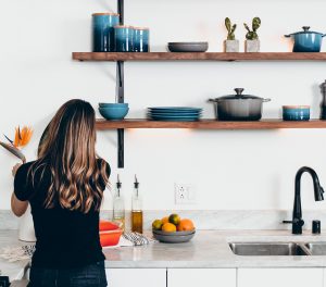 Woman unpacking her kitchen in her new custom home.