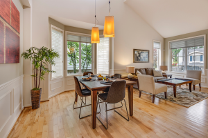 Open concept dining room and living room with lots of natural lighting.