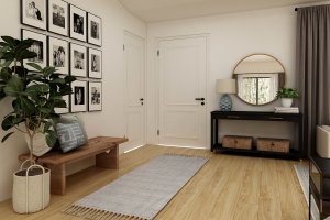 Entry way of custom home with photos on left wall, table and mirror on far wall next to door and a runner carpet on the ground.