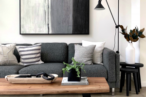 A monochromatic living room with a gray couch.