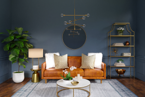 A living room with a cognac leather couch, gold bookcase, gold geometric chandelier, white marble coffee table and blue walls.
