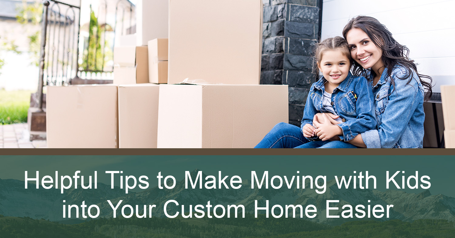 A woman sitting next to moving boxes getting ready to start moving with kids into a custom home.